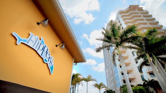 flippers logoed sign and image of the resort